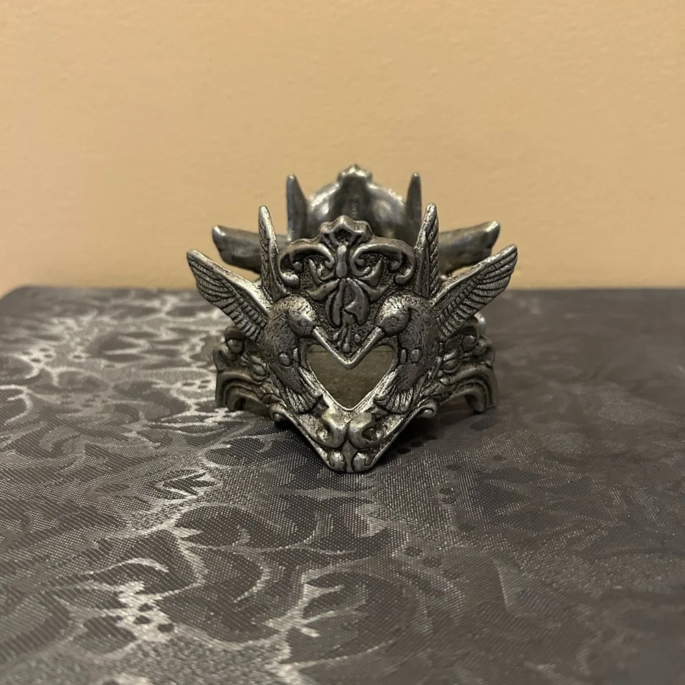 Pewter candle holder features hummingbirds and hearts
